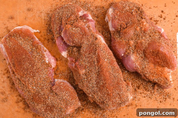 Applying dry rub to country style ribs.