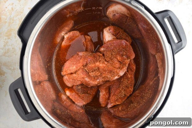 Country style ribs, beef broth, and barbecue sauce in Instant Pot.