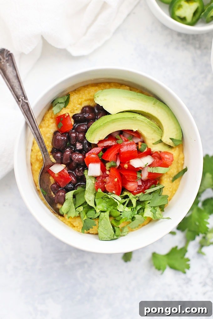 Black bean polenta bowl topped with salsa and avocado