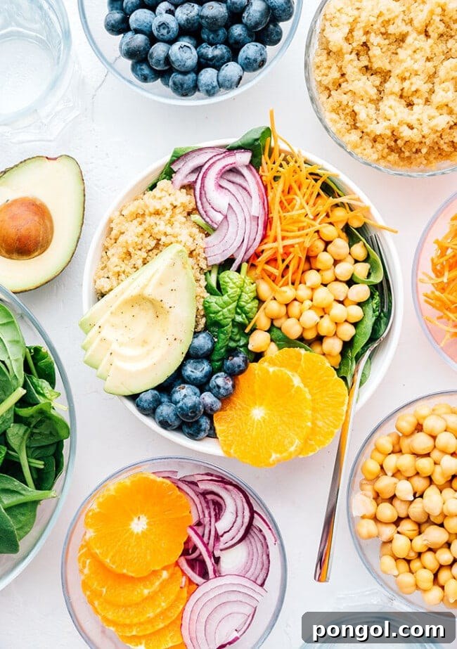 Vibrant Buddha bowl with red onion, chickpeas, grains, avocado, and blueberries