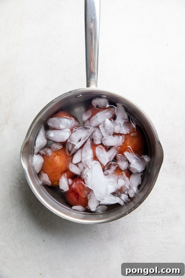 Boiled potatoes being prepared for mashing