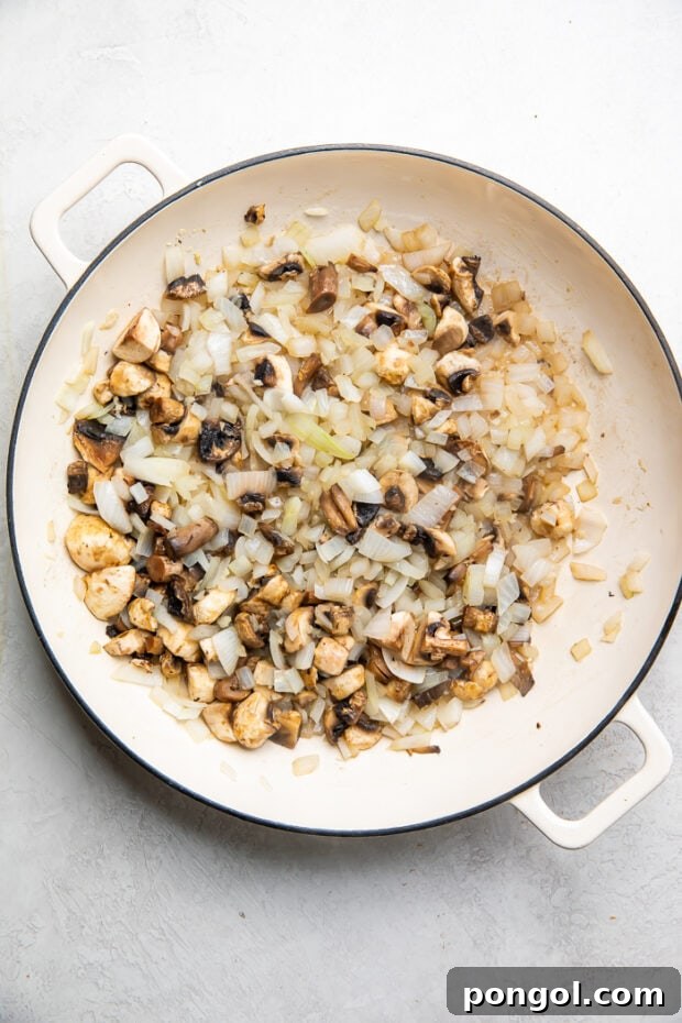Onions, garlic, and mushrooms sautéing in a skillet