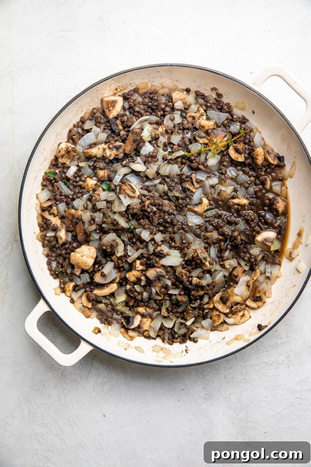 Lentil and mushroom filling simmering in a skillet