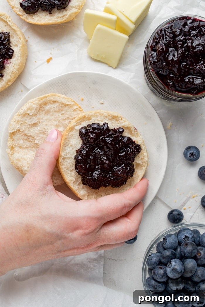 Close-up of freshly made blueberry jam in jars, ready for storage.