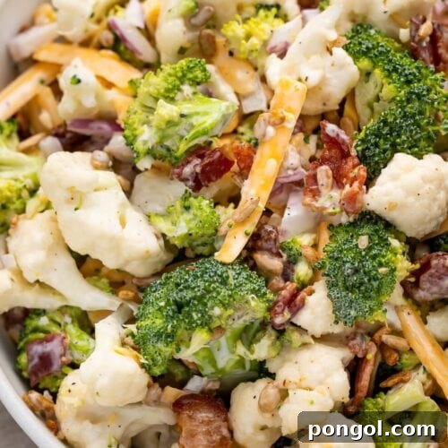Close up of broccoli cauliflower salad in a bowl.