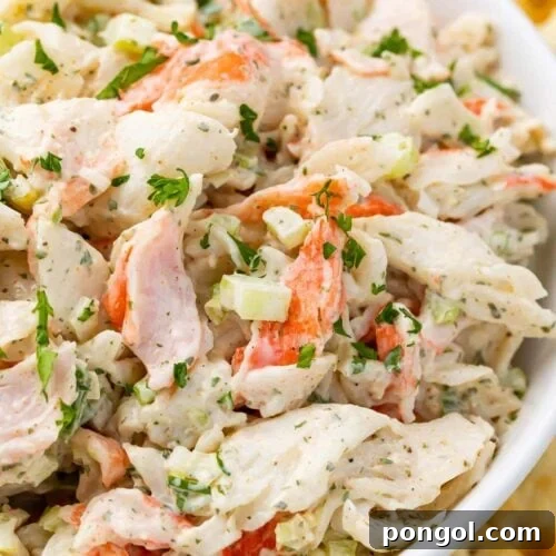 Crab salad in a bowl with an array of saltine crackers