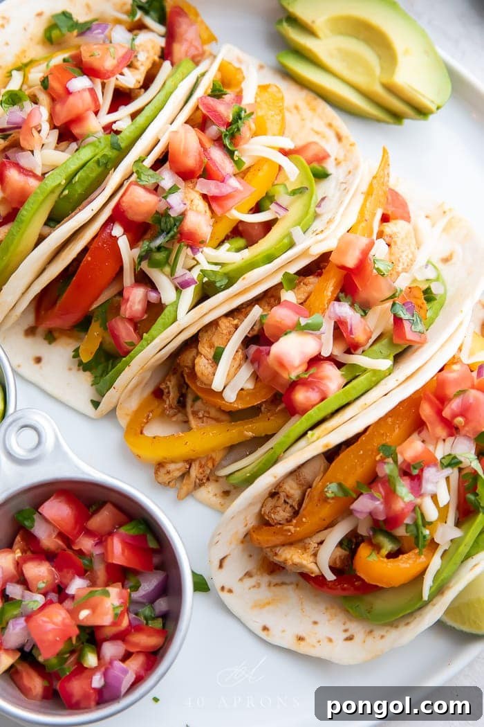 Mexican Chicken Extravaganza 28 Crockpot chicken fajitas arranged on a white plate next to a bowl of chunky salsa.