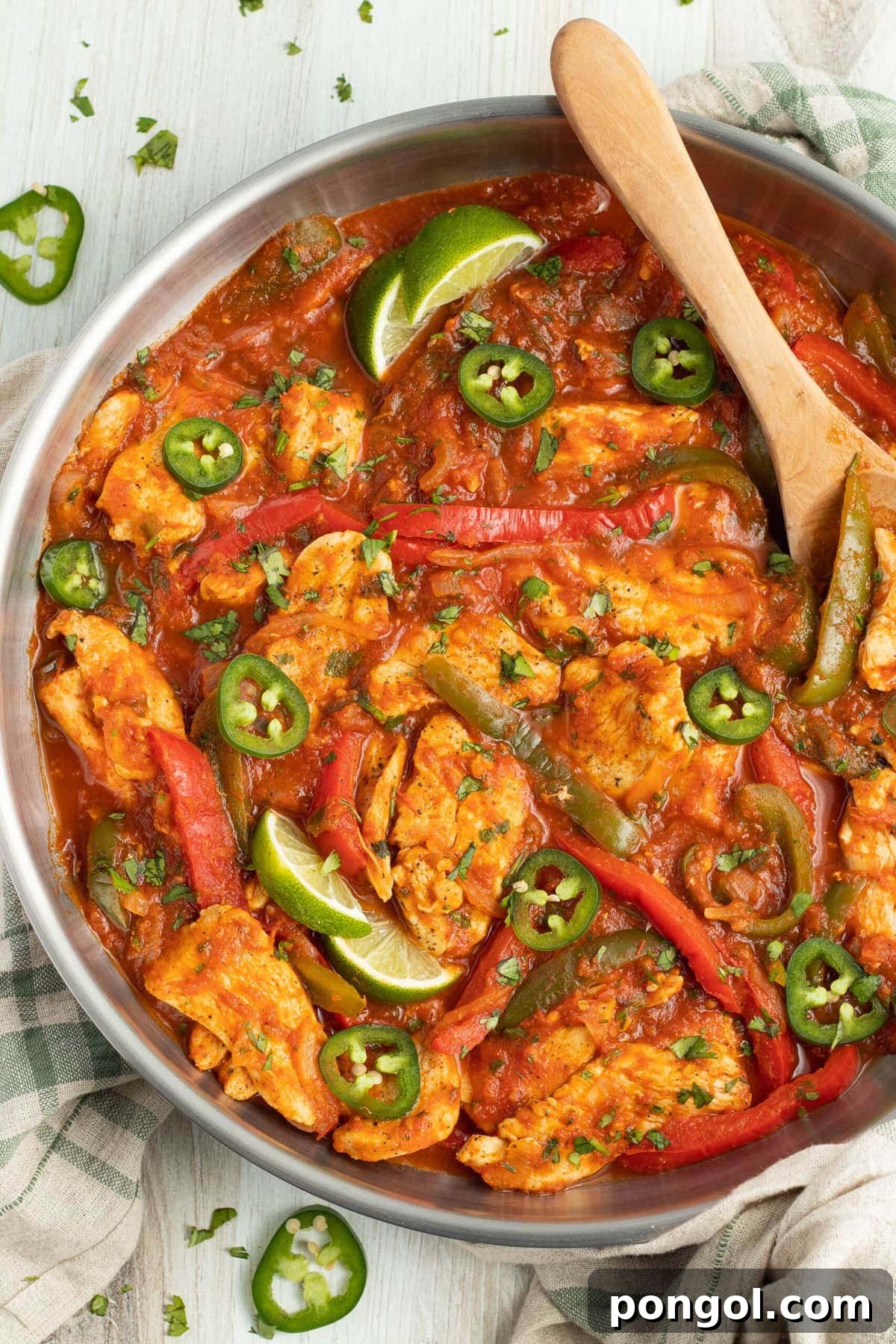 Mexican Chicken Extravaganza 5 Chicken Ranchero served in a skillet with vibrant bell peppers and onions, ready to be enjoyed.