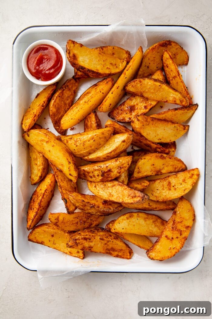 Air fryer potato wedges on a baking sheet