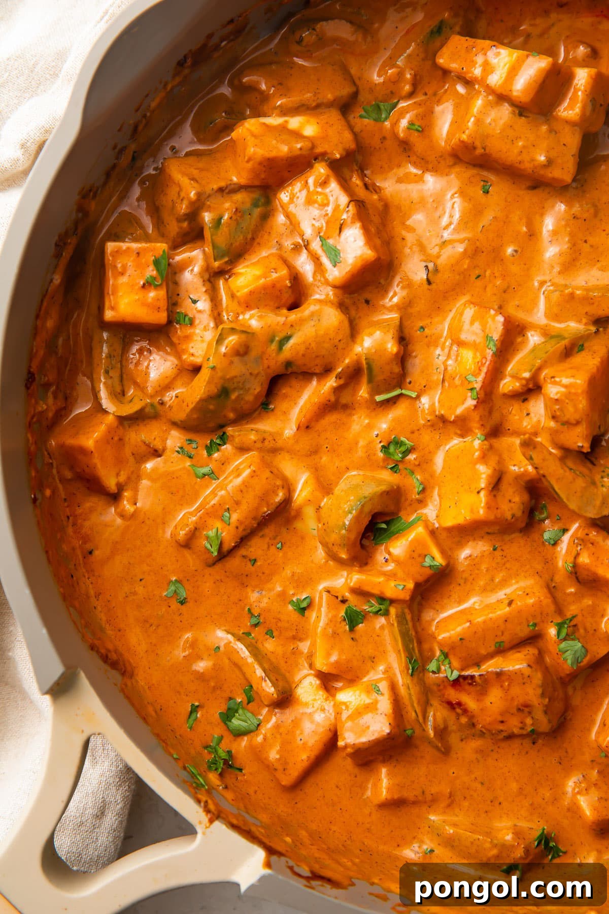 Creamy Paneer Tikka Masala 3 Deep orange paneer tikka masala in a large skillet.