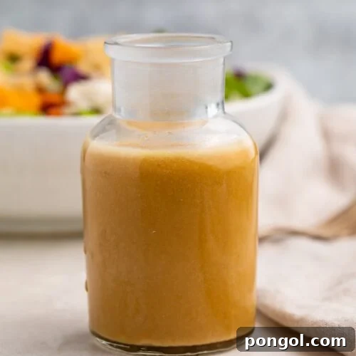 A glass bottle of Asian salad dressing