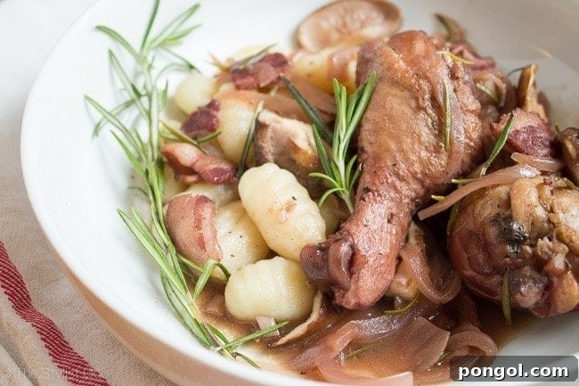 Red Wine-Braised Chicken with Rosemary and Mushrooms simmering