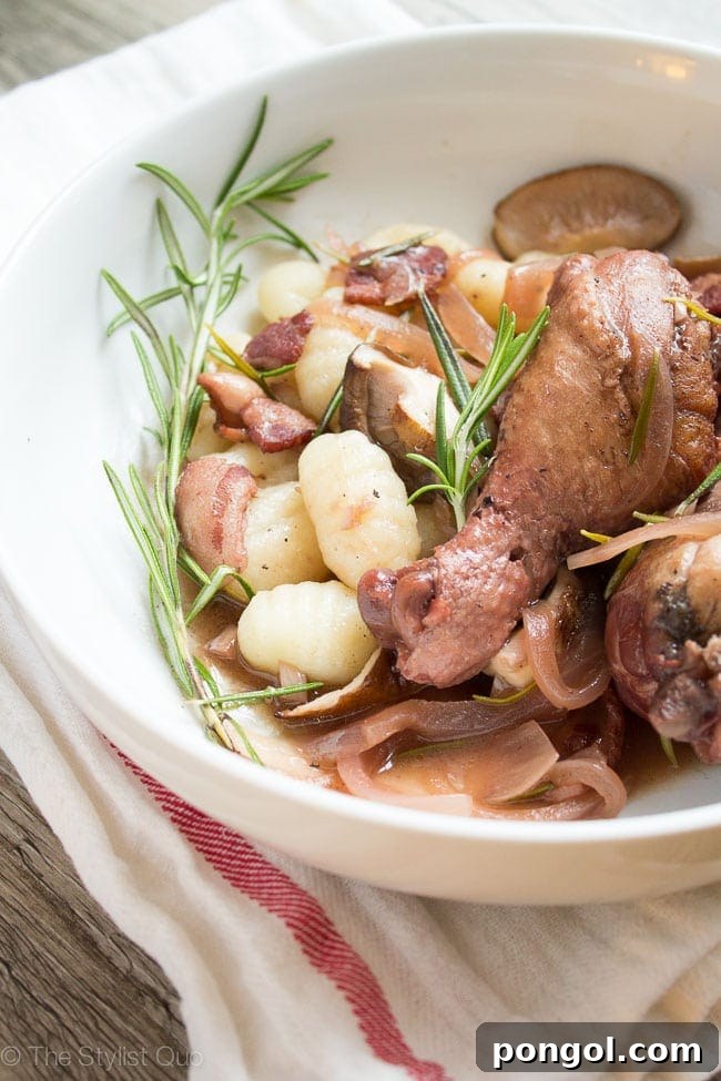 Close-up of braised chicken with rosemary and mushrooms