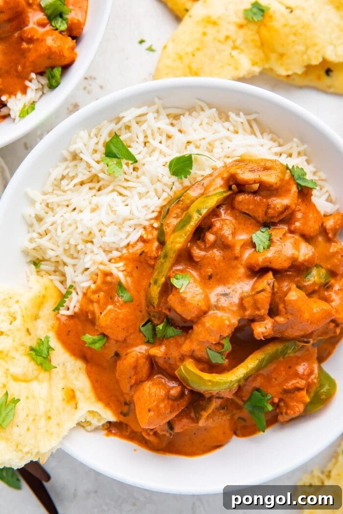 Instant Pot Chicken Tikka Masala in a bowl with basmati rice and naan