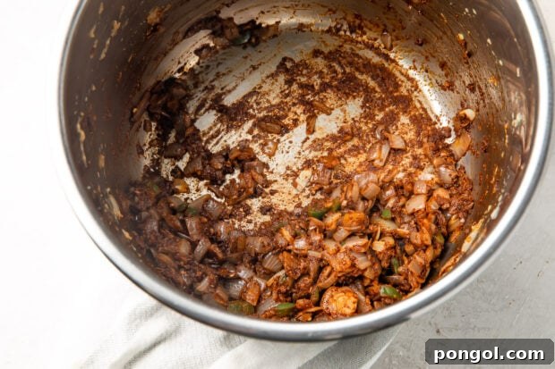 Adding spices to the caramelized aromatics