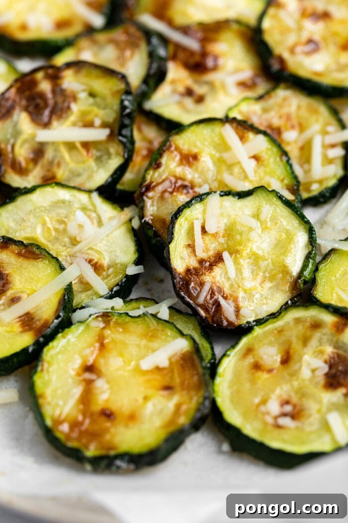 Crispy Air Fryer Zucchini 3 Close-up image of perfectly golden and crispy air fried zucchini slices, showing their appetizing texture.