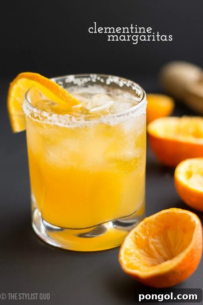 Fresh Clementine Margaritas, perfect for any celebration, showcasing the vibrant orange hue of clementine juice with a salted rim.