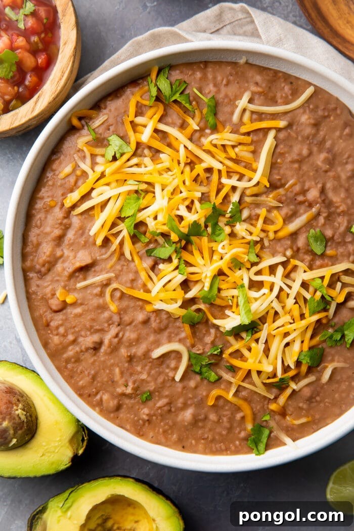 Instant Pot refried beans in a large bowl, ready to be served or stored.