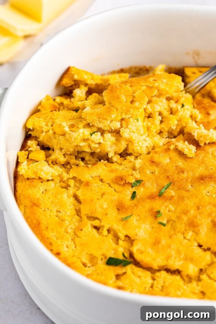 Golden Cornbread Delight 2 A golden-brown cornbread casserole in a baking dish, ready to be served, highlighting its fluffy texture and inviting crust.
