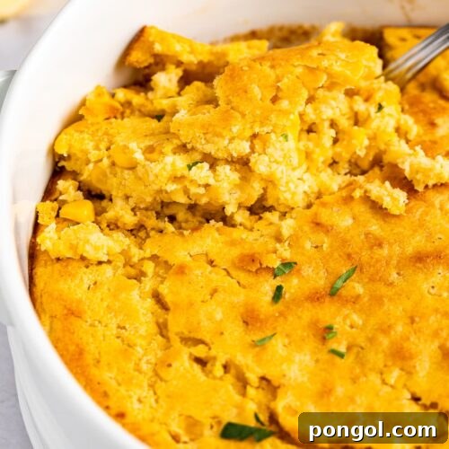 Golden Cornbread Delight 4 An oval casserole dish holding cornbread casserole, golden and inviting.