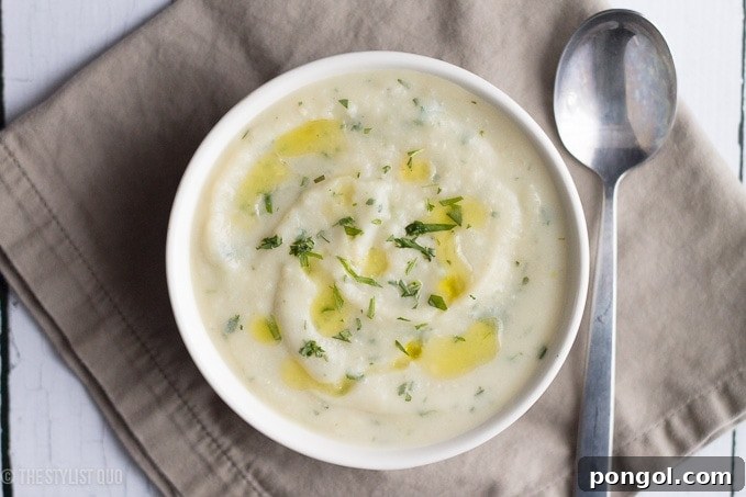 Bowl of Leftover Mashed Potato Soup garnished with fresh tarragon