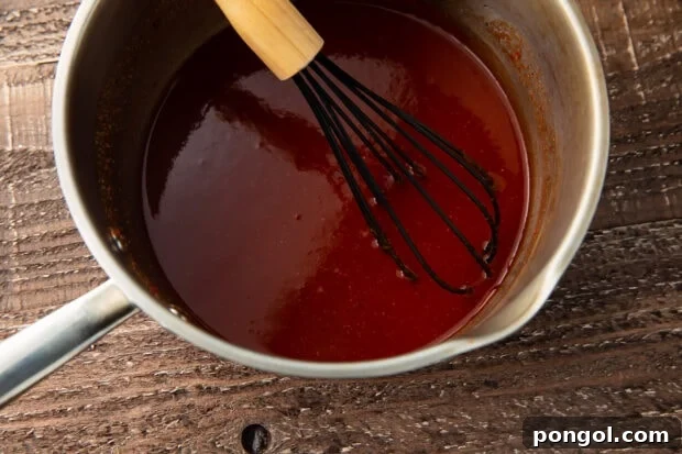 Smoky Keto BBQ Perfection 5 Keto bbq sauce in a saucepan with a whisk