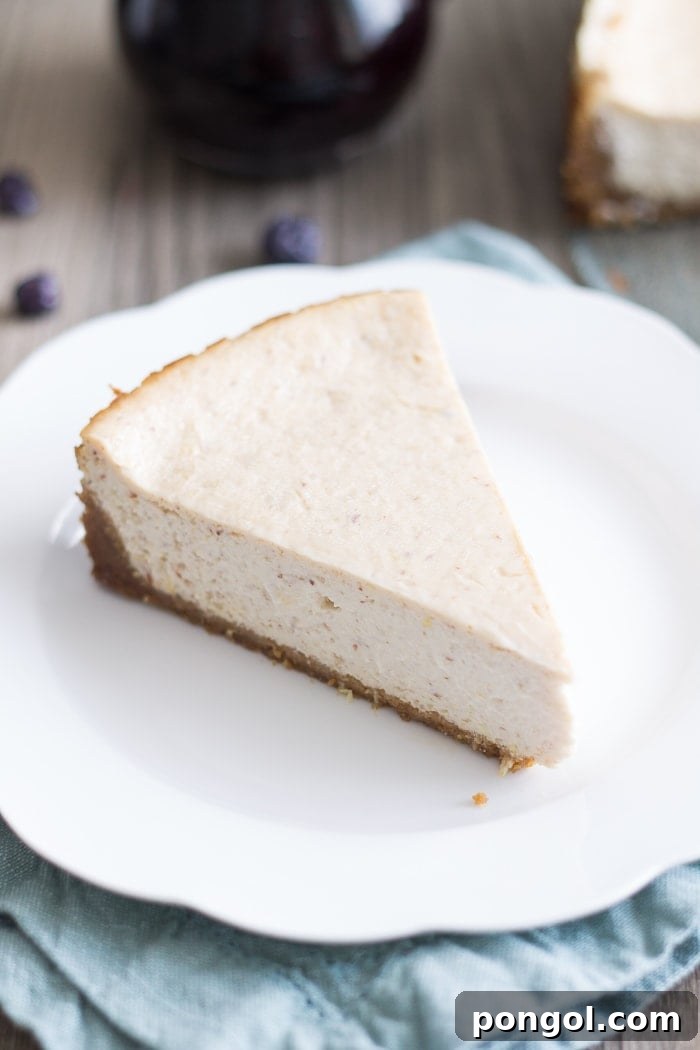 Close-up of the smooth, creamy texture of a Vegan Lemon Ricotta Cheesecake slice, ready to be enjoyed