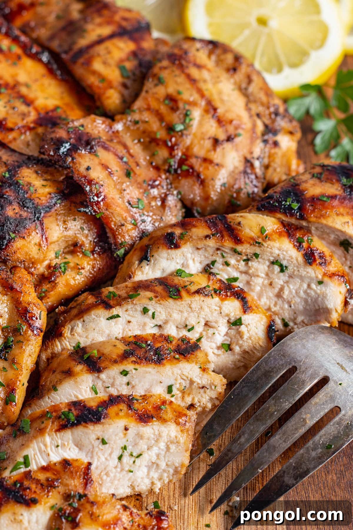 125 Simple Chicken Dinners: Fast Meals with Pantry Staples 115 Juicy mesquite grilled chicken, with a chicken breast sliced thick to show the inside meat.