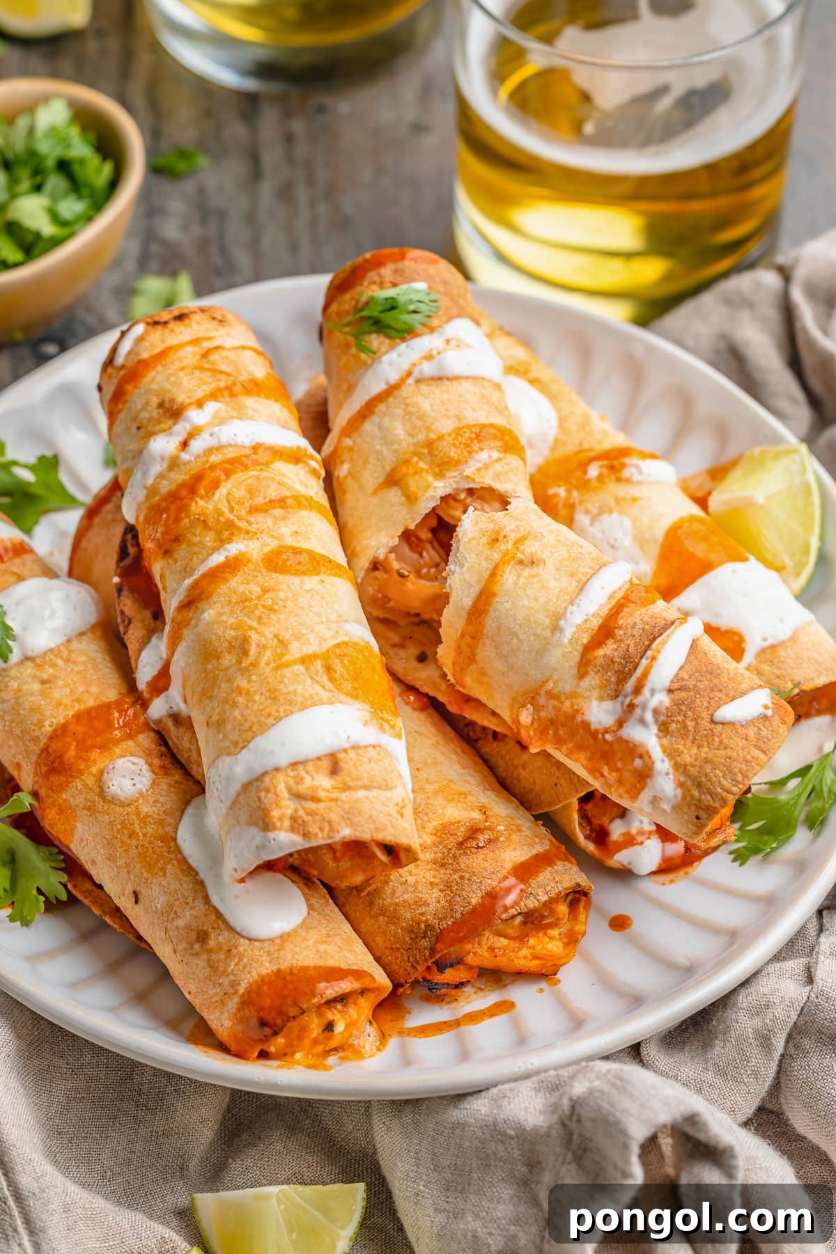 125 Simple Chicken Dinners: Fast Meals with Pantry Staples 116 5-ingredient air fryer flautas stacked on a plate and topped with queso.