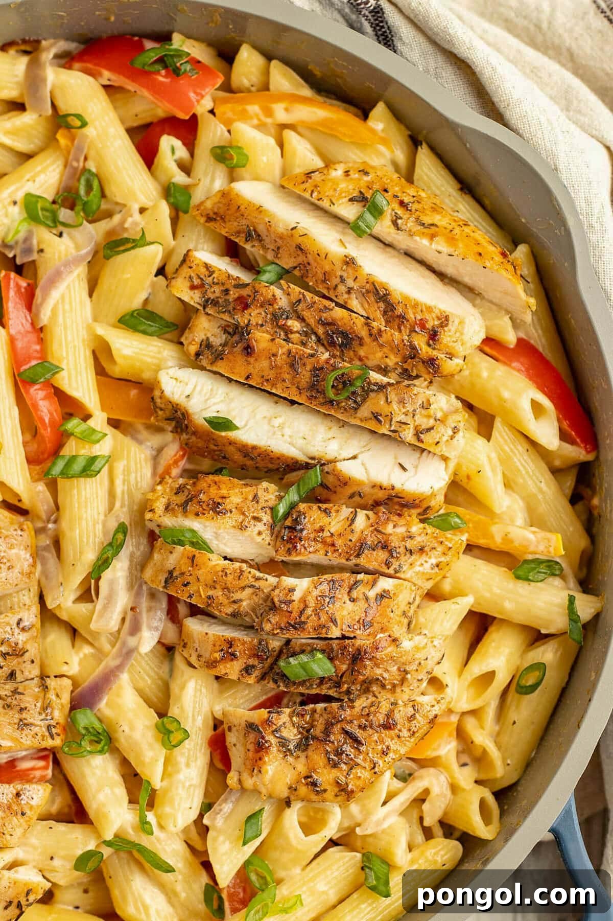 125 Simple Chicken Dinners: Fast Meals with Pantry Staples 120 Jerk chicken pasta in a large skillet with fresh herbs, red tomato, and creamy penne.