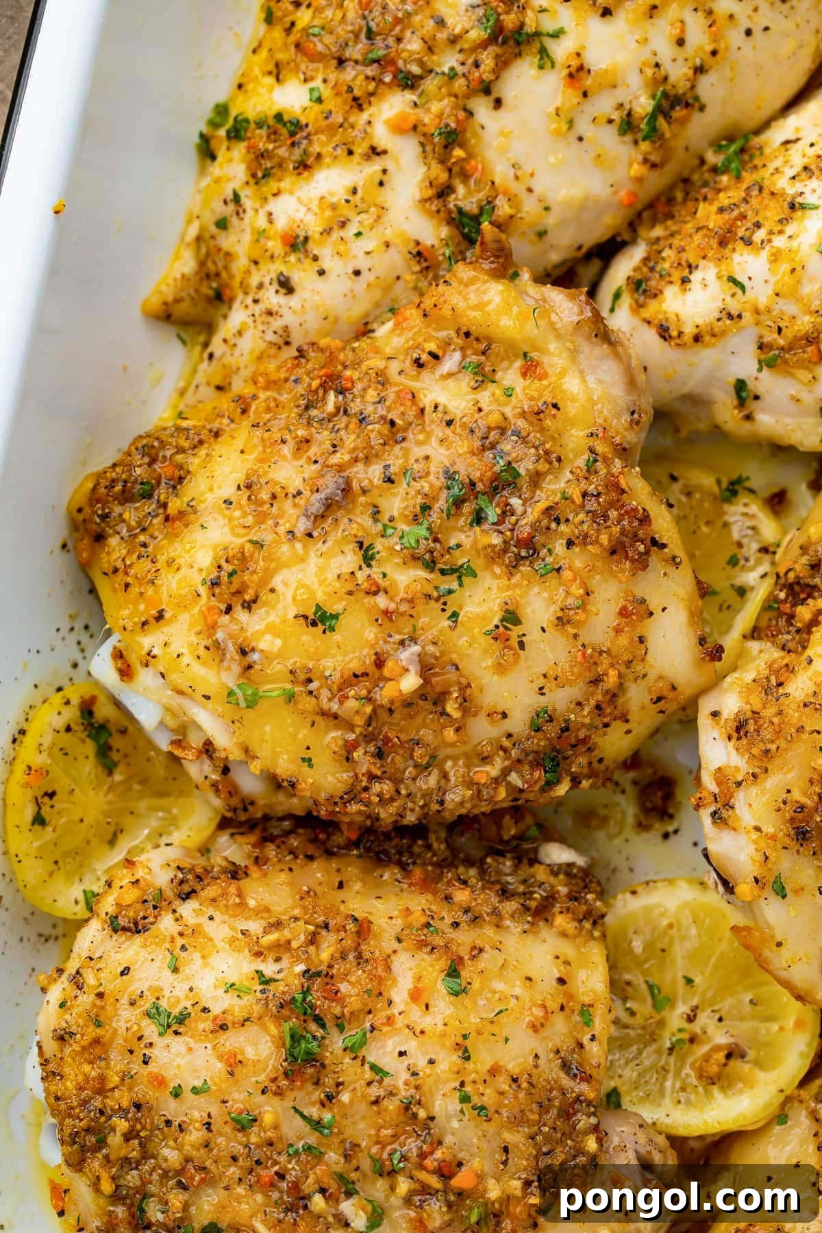 125 Simple Chicken Dinners: Fast Meals with Pantry Staples 20 Lemon pepper seasoned chicken thighs in a casserole dish with lemon discs.