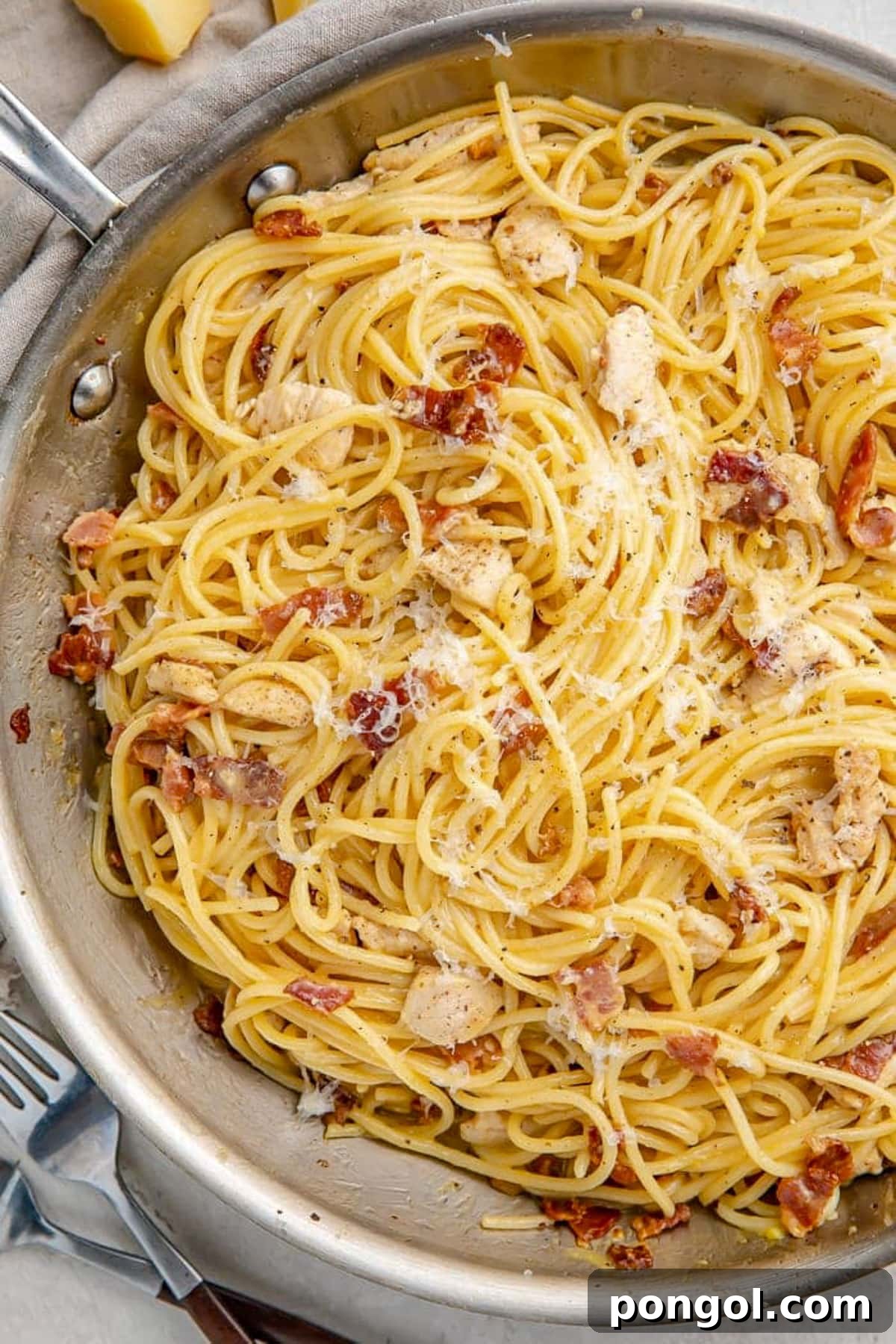 125 Simple Chicken Dinners: Fast Meals with Pantry Staples 23 Chicken carbonara with angel hair pasta in a large silver skillet.