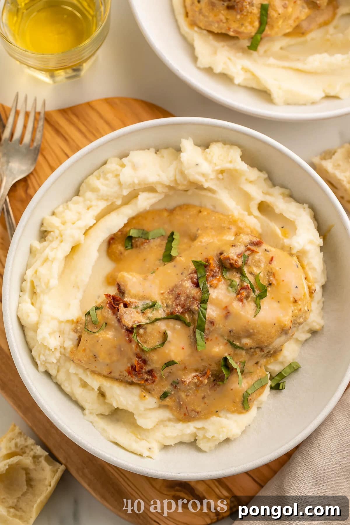 125 Simple Chicken Dinners: Fast Meals with Pantry Staples 44 Crockpot marry me chicken topped with basil and sun-dried tomatoes on a bed of mashed potatoes.