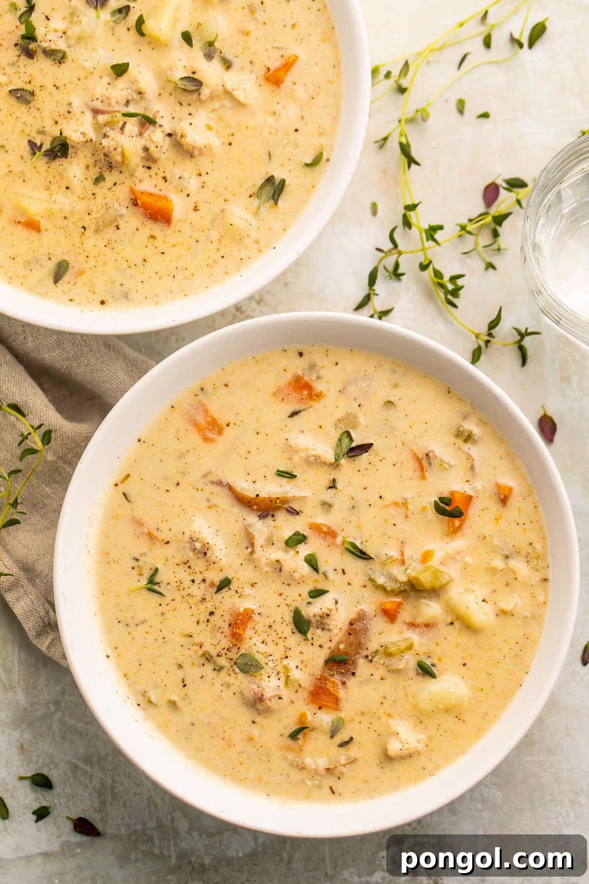 125 Simple Chicken Dinners: Fast Meals with Pantry Staples 54 Two bowls of Instant Pot chicken pot pie soup on a table.