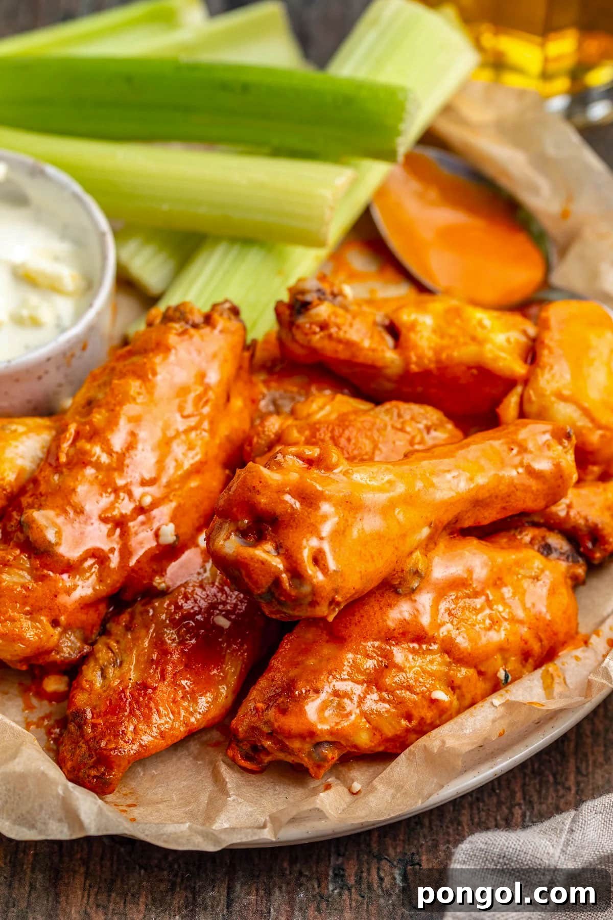 125 Simple Chicken Dinners: Fast Meals with Pantry Staples 81 Buffalo chicken wings cooked sous vide on a platter with celery sticks and blue cheese dressing.