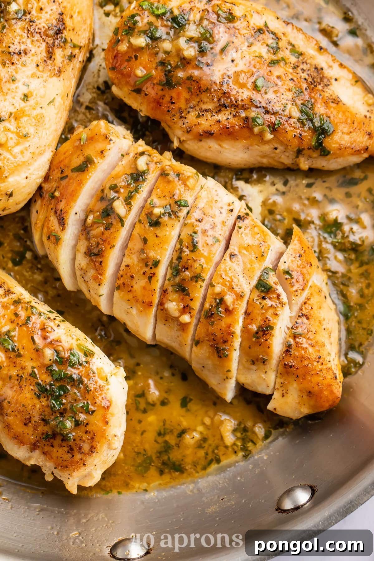 125 Simple Chicken Dinners: Fast Meals with Pantry Staples 85 Sliced chicken breast in a large skillet with a garlic butter sauce.