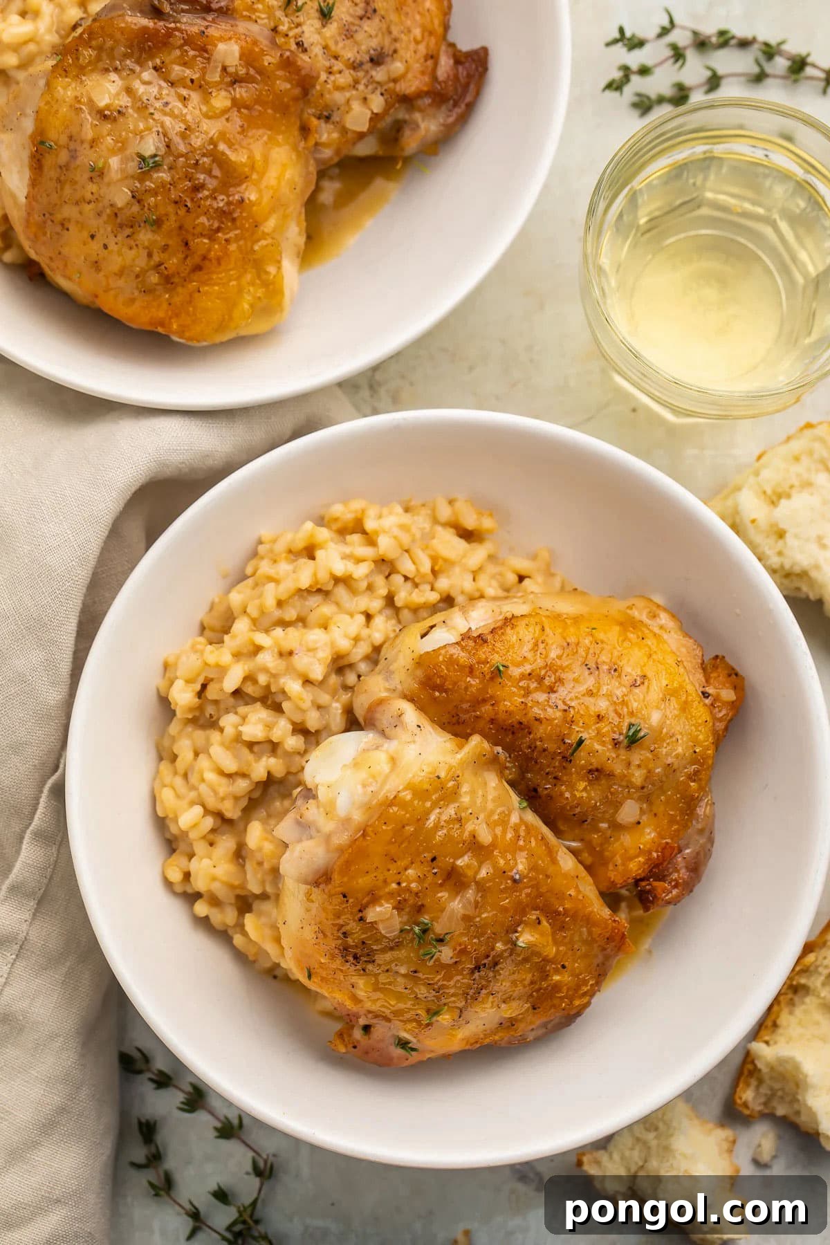 125 Simple Chicken Dinners: Fast Meals with Pantry Staples 10 Top-down photo of pan-seared chicken thighs in large white shallow bowls with creamy risotto.