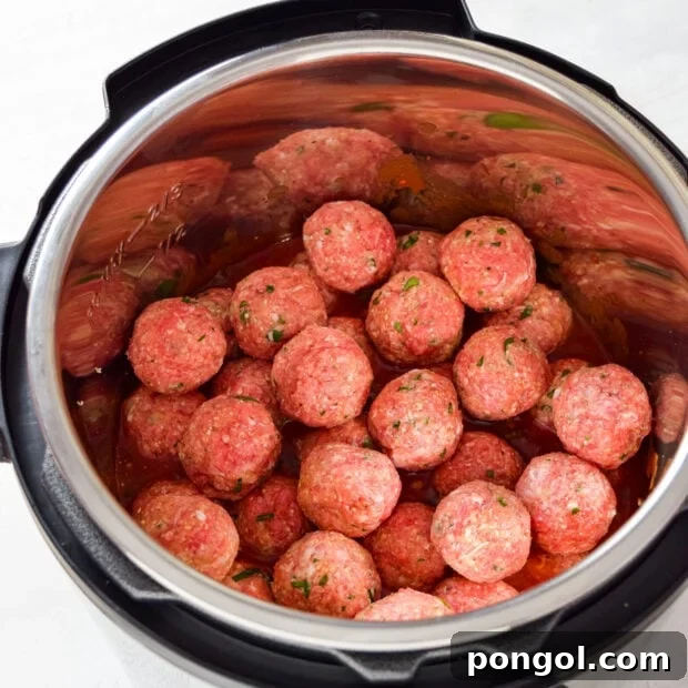 Meatballs added to Instant Pot with sauce.