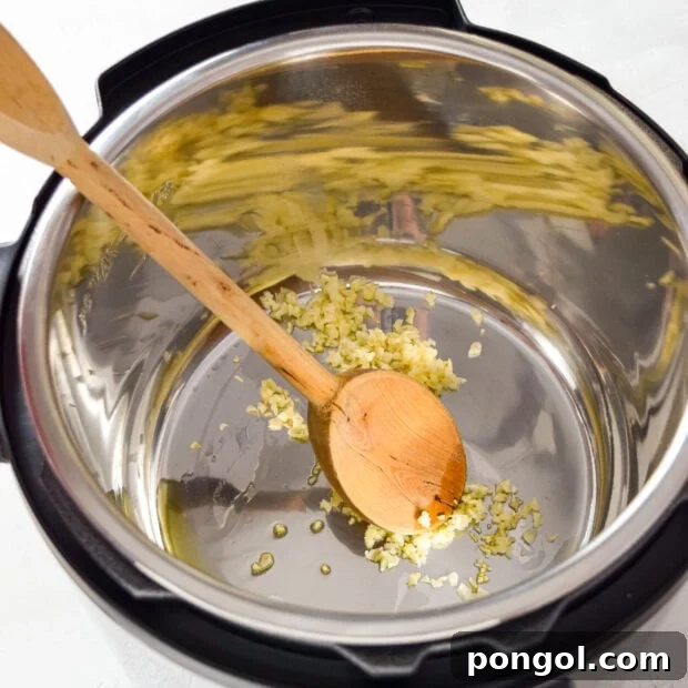 Sautéing garlic in Instant Pot for sauce.