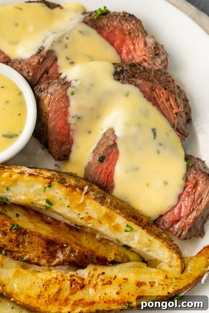 Sheet pan steak and fries with microwave bearnaise sauce on a white plate