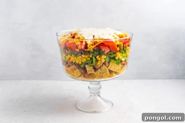 Pouring ranch dressing over the salad