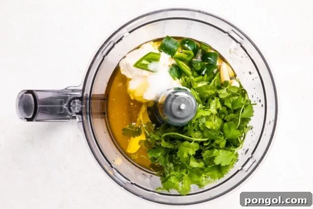 Cilantro and lime dressing ingredients in a food processor.