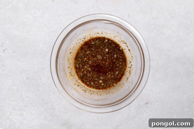 Wok-Tossed Beef Noodles 7 A small bowl containing the mixed lo mein sauce ingredients, ready to be added to the dish.