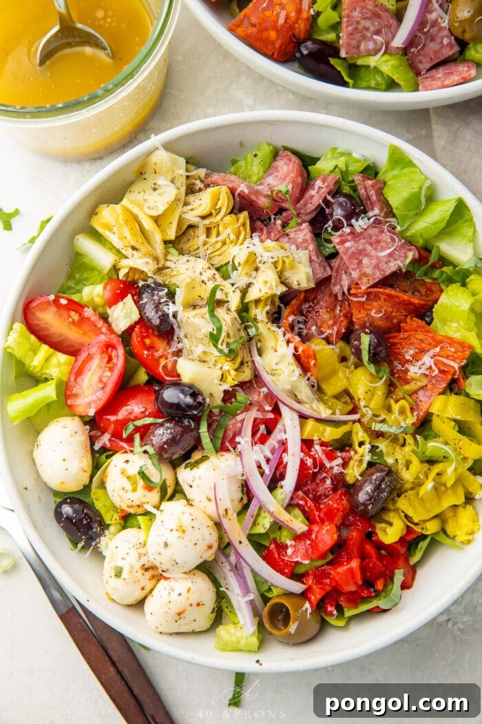 Effortless Antipasto Salad with Bright Italian Vinaigrette 2 Antipasto salad in a large white bowl, taken from above.