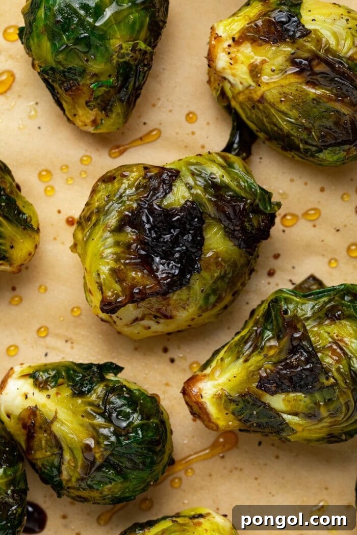 Close up image of perfectly charred and grilled Brussels sprouts.