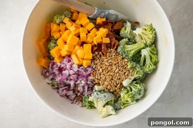 Ingredients for keto broccoli salad in a large bowl