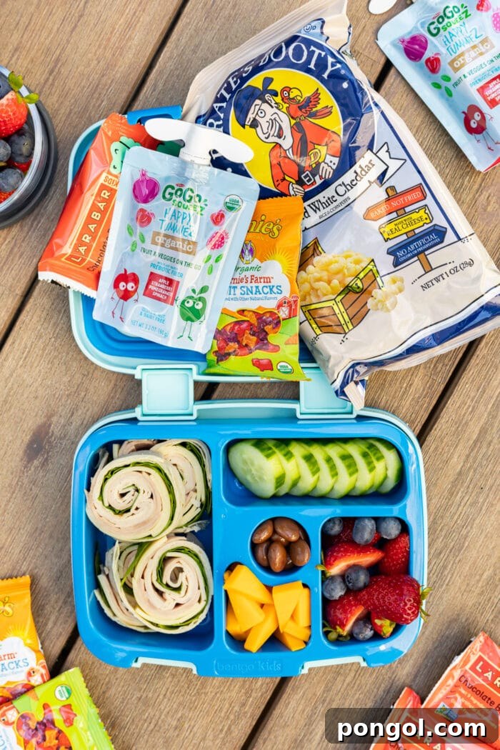 Bento box filled with snacks and a small cooler in a car seat