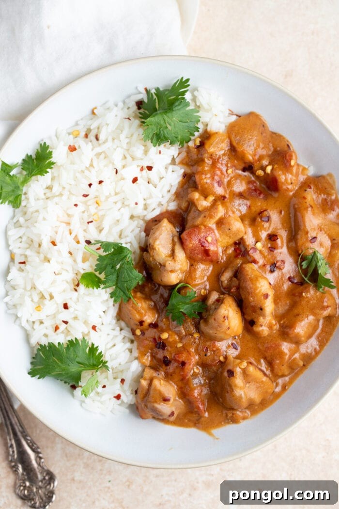Rich and Creamy Peanut Chicken 3 Peanut butter chicken in a white bowl set on top of a napkin