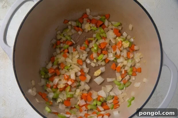 Veggies in a large pot for tomato bisque