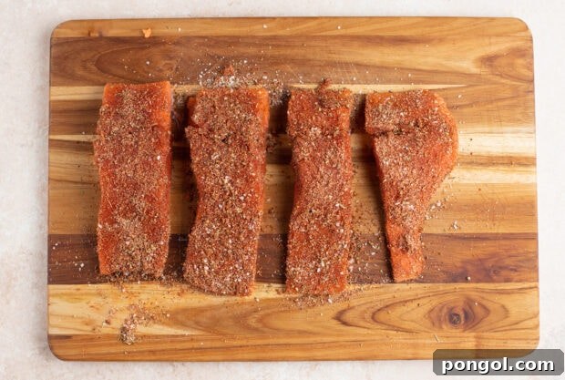 Spice rubbed salmon filets on a cutting board